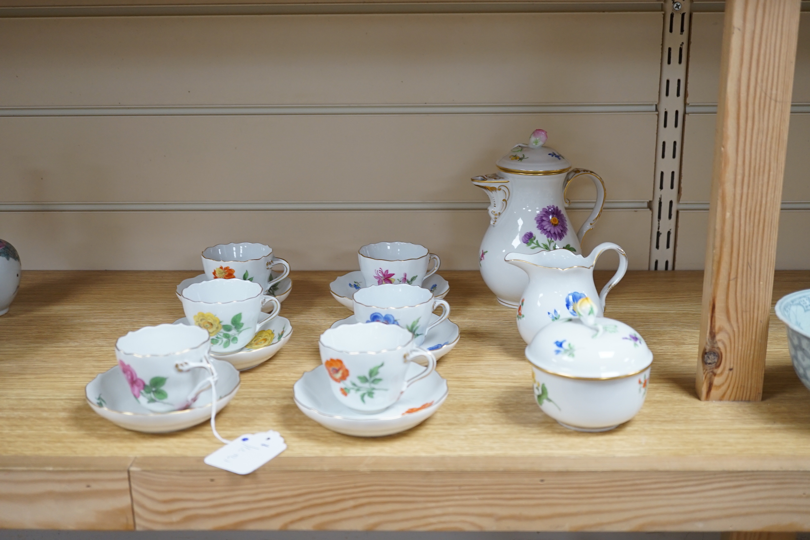 A 20th century Meissen coffee set with floral decoration, comprising a coffee pot, a milk jug, a lidded sugar bowl, and six cups and saucers, coffee pot, 17cm high